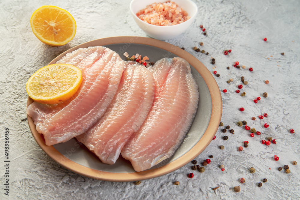 Tilapia fish fillet with spices and lemon. Healthy food rich in proteins. Tilapia fish fillet with spices and lemon. Healthy food rich in proteins.