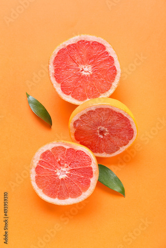 Fresh grapefruit pieces on orange background