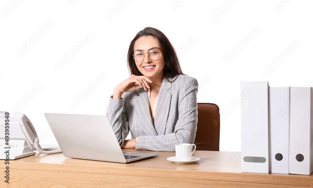 Young secretary with laptop at table on white background Young secretary with laptop at table on white background