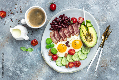 Healthy nutritious paleo keto breakfast diet lunch avocado, fried eggs, bacon, beans and coffee. Ketogenic diet concept. Restaurant menu, dieting, cookbook recipe top view