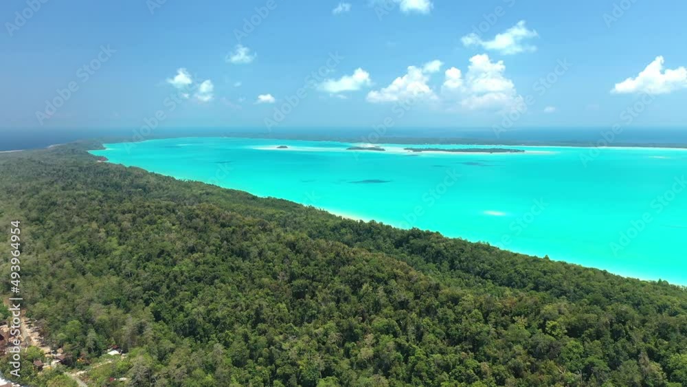 Drone view of surroundings on a tropical island, turquoise lagoon , coral reef , and deep blue see