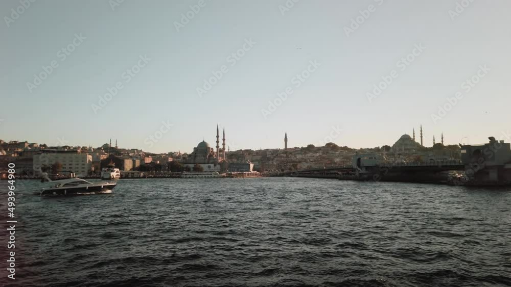 Istanbul, Turkey -; View from a boat sailing under a bridge in Istanbul. Panning shot of golden horn Galata haliç and eminönü side aerial shooting Istanbul, Turkey -; View from a boat sailing under a bridge in Istanbul. Panning shot of golden horn Galata haliç and eminönü side aerial shooting