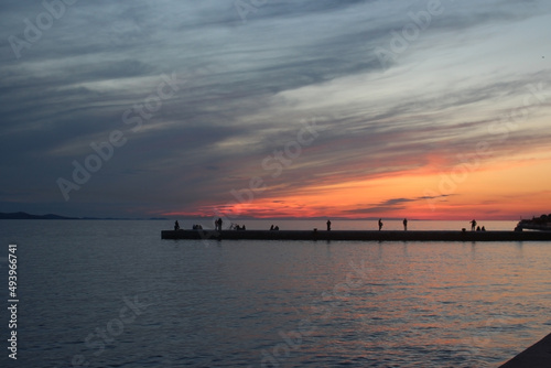 Sunset time in beach , people are fishing watching sunset , Colorful Sun Croatia Zadar