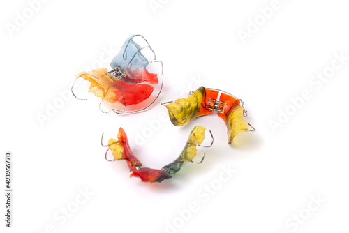 Colorful children's orthodontic appliances isolated on white background. Concept of oral health in childhood.