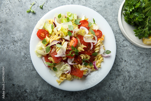 Pasta salad with mozzarella, red onion and tomato