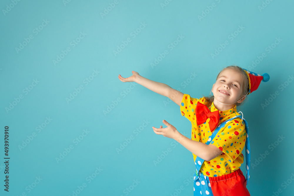 Funny kid clown against blue background. Birthday and 1 April Fool's day concept. Copy space Funny kid clown against blue background. Birthday and 1 April Fool's day concept. Copy space