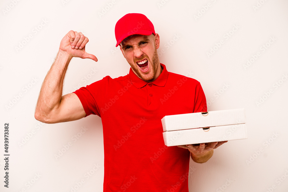 Young delivery caucasian man holding pizzas isolated on white background feels proud and self confident, example to follow. Young delivery caucasian man holding pizzas isolated on white background feels proud and self confident, example to follow.