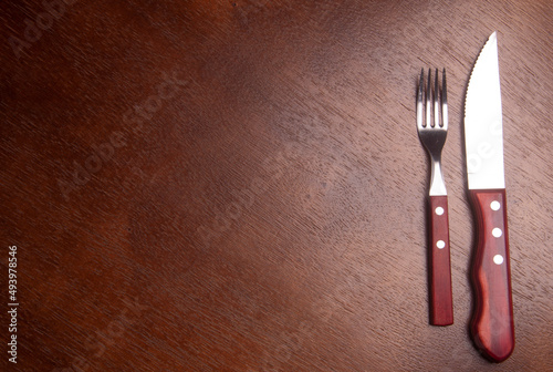 empty wood table with fork and knife - hungry