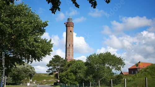 Old lighthouse on the island Norderney. The brick tower is over 150 years old and is a popular tourist attraction. photo