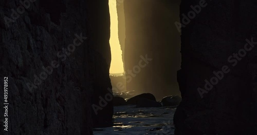 Sunlight Illuminated Through Zawn Pyg Natural Arch With Crashing Waves At Nanjizal Beach In Cornwall, United Kingdom. Close Up photo