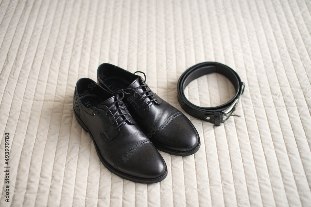 Black men's shoes with laces and a black belt Black men's shoes with laces and a black belt
