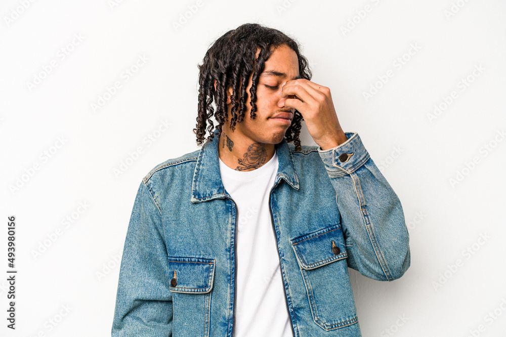 Young African American man isolated on white background having a head ache, touching front of the face. Young African American man isolated on white background having a head ache, touching front of the face.