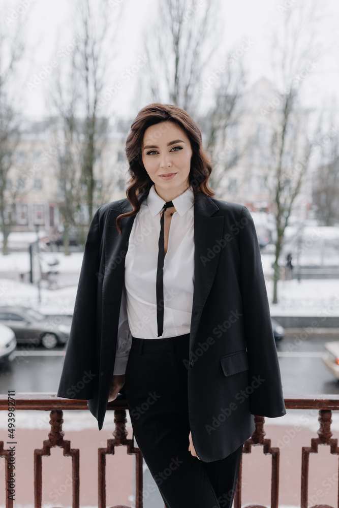 Half-length portrait of a young successful girl in a jacket on the street. Half-length portrait of a young successful girl in a jacket on the street.
