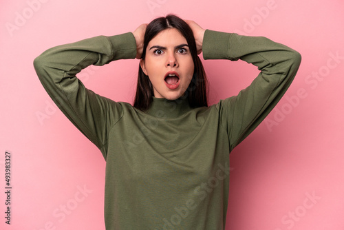 Young caucasian woman isolated on pink background surprised and shocked. © Asier