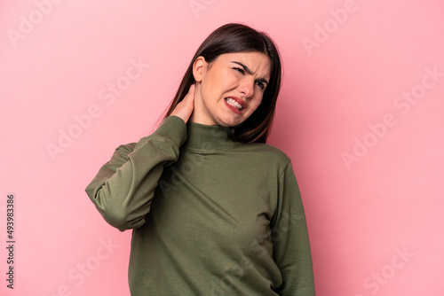 Young caucasian woman isolated on pink background suffering neck pain due to sedentary lifestyle. © Asier