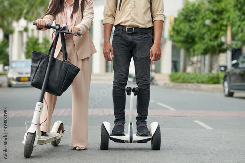 Cropped image of young couple riding around the city on modern personal transportation devices