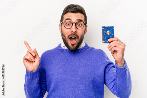 Young informatics caucasian man isolated on white background pointing to the side photo