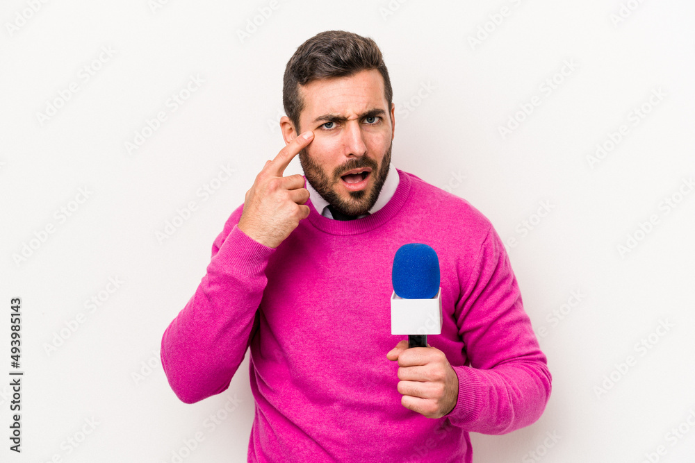 Young caucasian tv presenter man isolated on white background showing a disappointment gesture with forefinger.