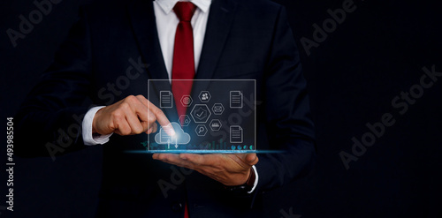 Businessman using tablet analyzing sales data Report and economic growth graph chart. Business technology economic strategy. Abstract icon. Digital marketing.
Businessman using tablet analyzing sales 