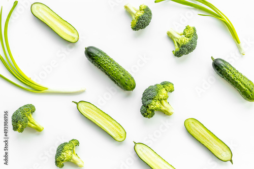 Flatlay of green vegetables - broccoli and cucumber. Food background