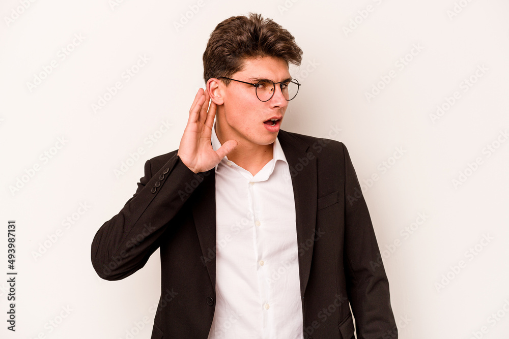 Young caucasian business man isolated on white background trying to listening a gossip. Young caucasian business man isolated on white background trying to listening a gossip.