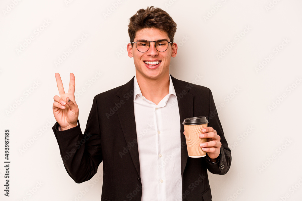 Young caucasian business man holding takeaway coffee isolated on white background joyful and carefree showing a peace symbol with fingers. Young caucasian business man holding takeaway coffee isolated on white background joyful and carefree showing a peace symbol with fingers.
