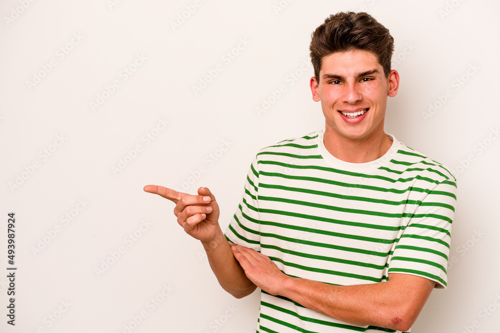 Young caucasian man isolated on white background smiling cheerfully pointing with forefinger away. Young caucasian man isolated on white background smiling cheerfully pointing with forefinger away.