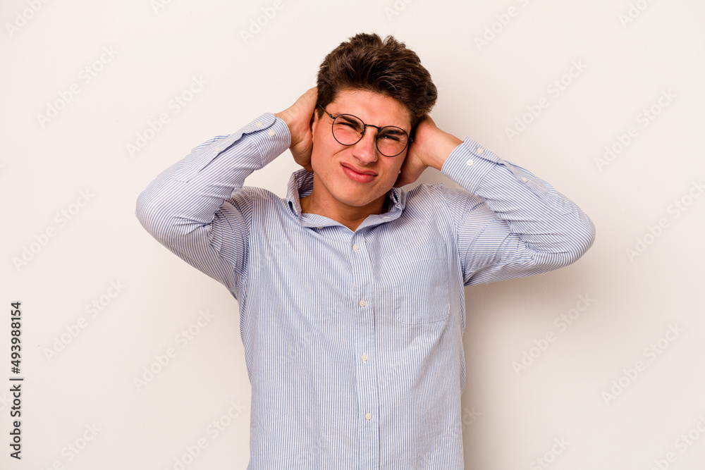 Young caucasian man isolated on white background covering ears with hands. Young caucasian man isolated on white background covering ears with hands.