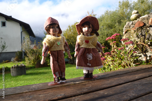 Closeup of two dollies in a yard of a villa, on the wooden desks 
 in Obertraun, Austria photo