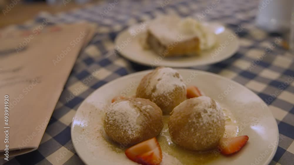 Doughnut and apple pie desserts on a checked tablecloth, restaurant. Doughnut and apple pie desserts on a checked tablecloth, restaurant.