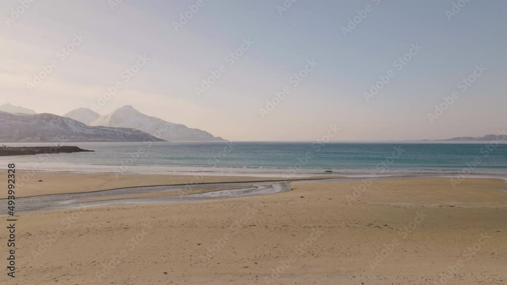 Rippling Waves Coming Toward the Shores of Grotfjord Beach Kvaloya Northern Norway - Forward dolly Drone Shot Rippling Waves Coming Toward the Shores of Grotfjord Beach Kvaloya Northern Norway - Forward dolly Drone Shot