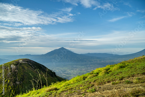 View of Indonesia's mountains with wide green grass photo
