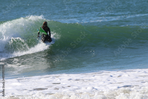 Photography Beautiful shot of a girl surfing in a big wave.