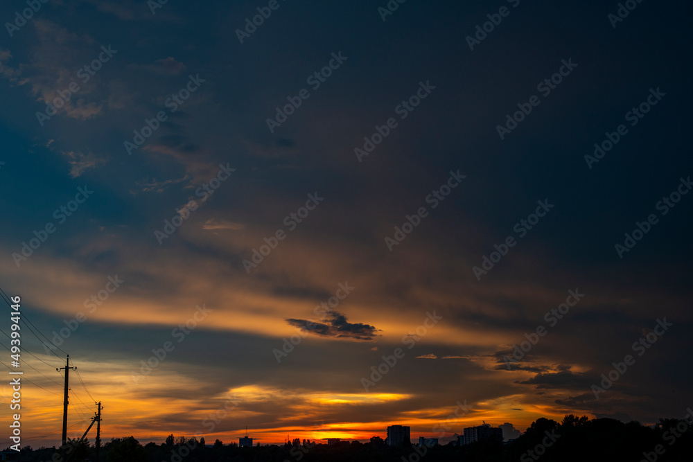 Natural Sunset Sunrise Over Field Or Meadow. Bright Dramatic Sky And Dark Ground. Countryside Landscape Under Scenic Colorful Sky At Sunset Dawn Sunrise. Sun Over Skyline, Horizon. Warm Colours