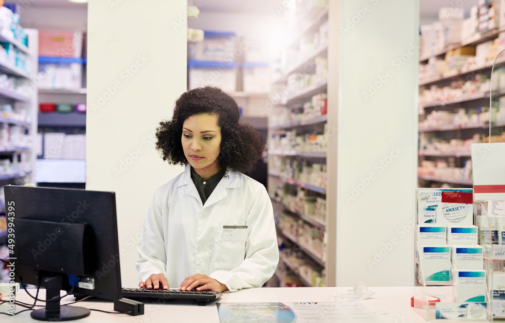 Ill get you the medication you need, when you need it. Cropped shot of a pharmacist working on a computer in a pharmacy.