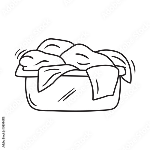 Outline doodle icon of dirty laundry. Hand drawn pile of clothes vector illustration. Textile heap isolated on white.