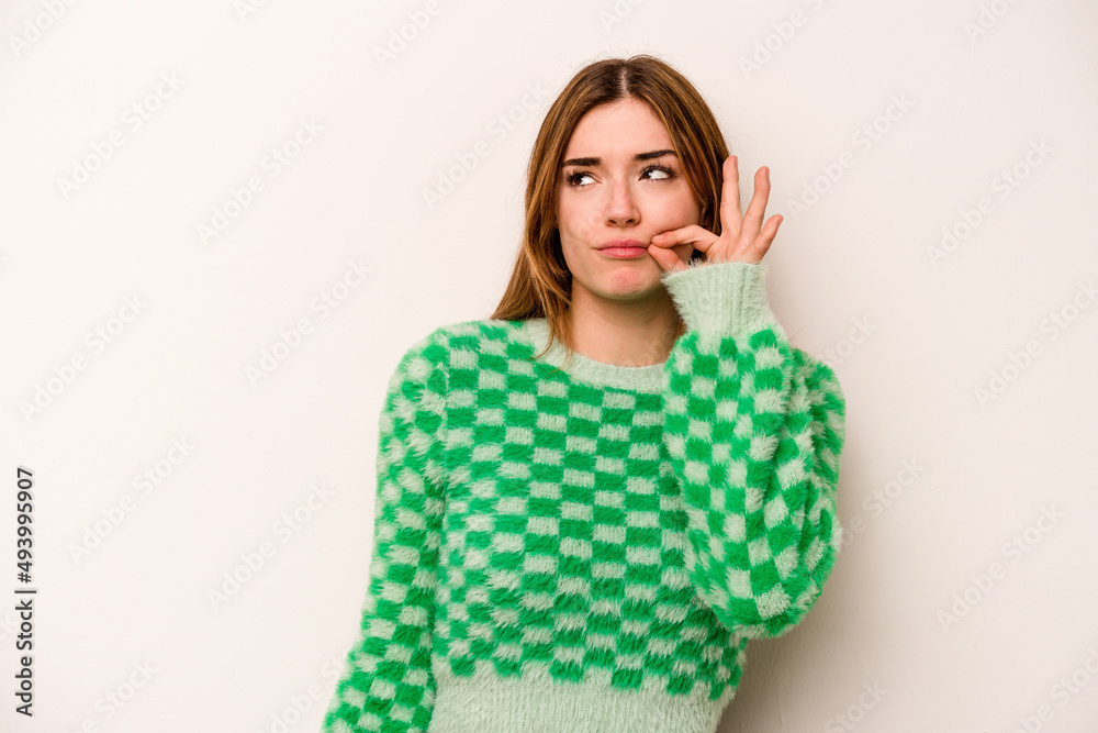Young caucasian woman isolated on white background with fingers on lips keeping a secret. Young caucasian woman isolated on white background with fingers on lips keeping a secret.