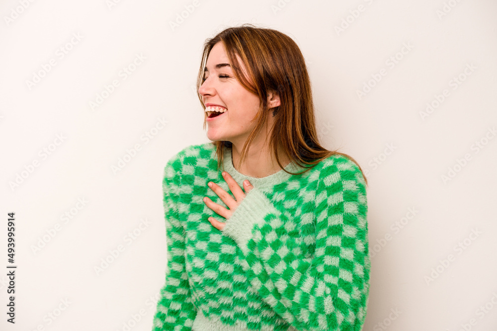 Young caucasian woman isolated on white background laughing keeping hands on heart, concept of happiness. Young caucasian woman isolated on white background laughing keeping hands on heart, concept of happiness.