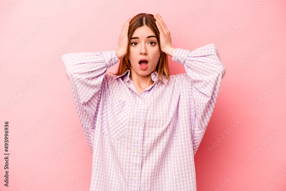 Young caucasian woman isolated on pink background being shocked, she has remembered important meeting. Young caucasian woman isolated on pink background being shocked, she has remembered important meeting.