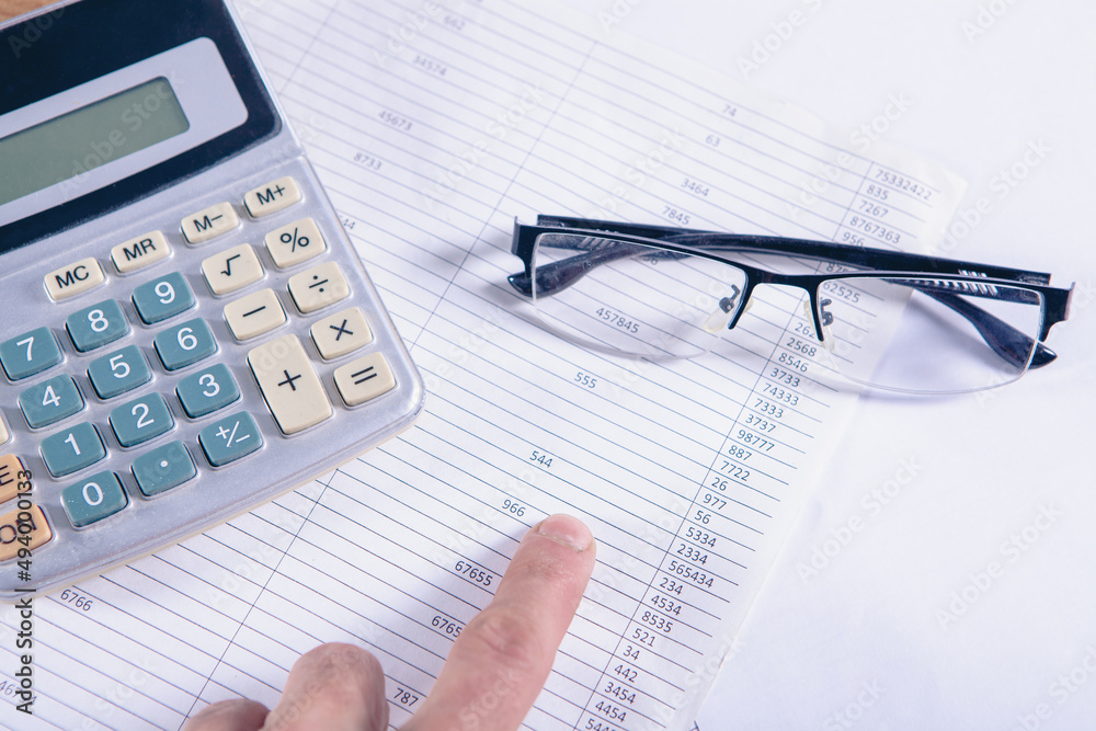 Close up calculator and financial report - accounting concept Close up calculator and financial report - accounting concept