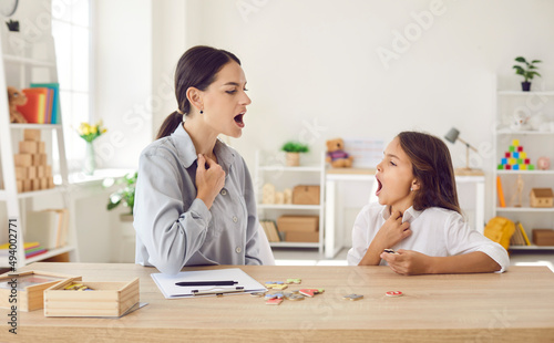 Speech-language pathologist working on child's pronunciation problems. Speech therapist teaching kid correct sound articulation, helping fix stuttering stammering impediment and boost self confidence