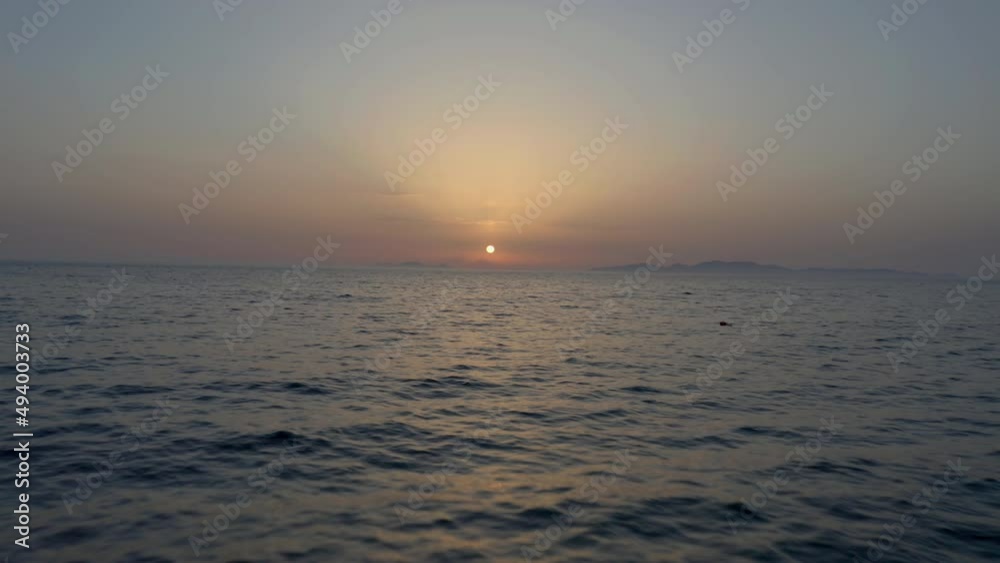 Aerial: Drone flying at low altitude over the sea during beautiful sunset Aerial: Drone flying at low altitude over the sea during beautiful sunset