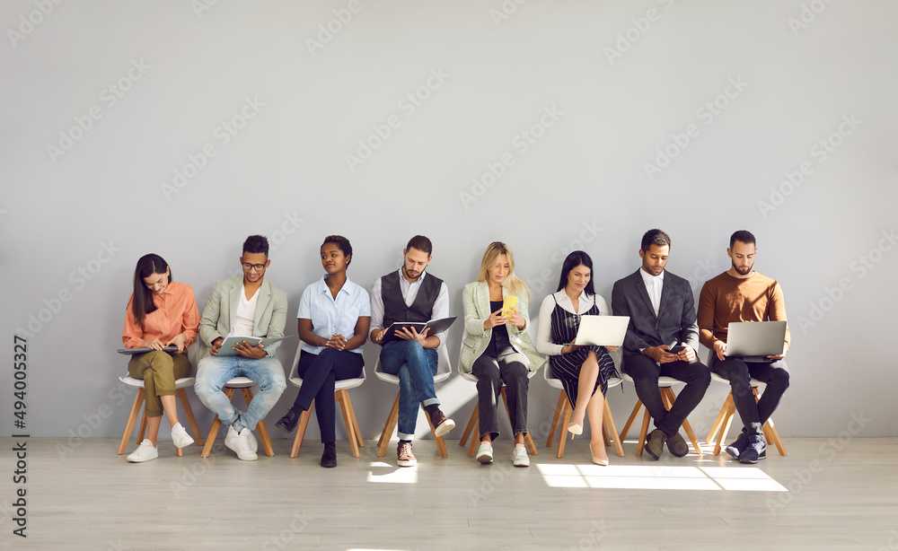 Modern way to communicate. Woman in row with people who came for interview and are busy reading resumes or surfing internet. Concept of human resources, employment, customers and electronic devices. - obrazy, fototapety, plakaty 