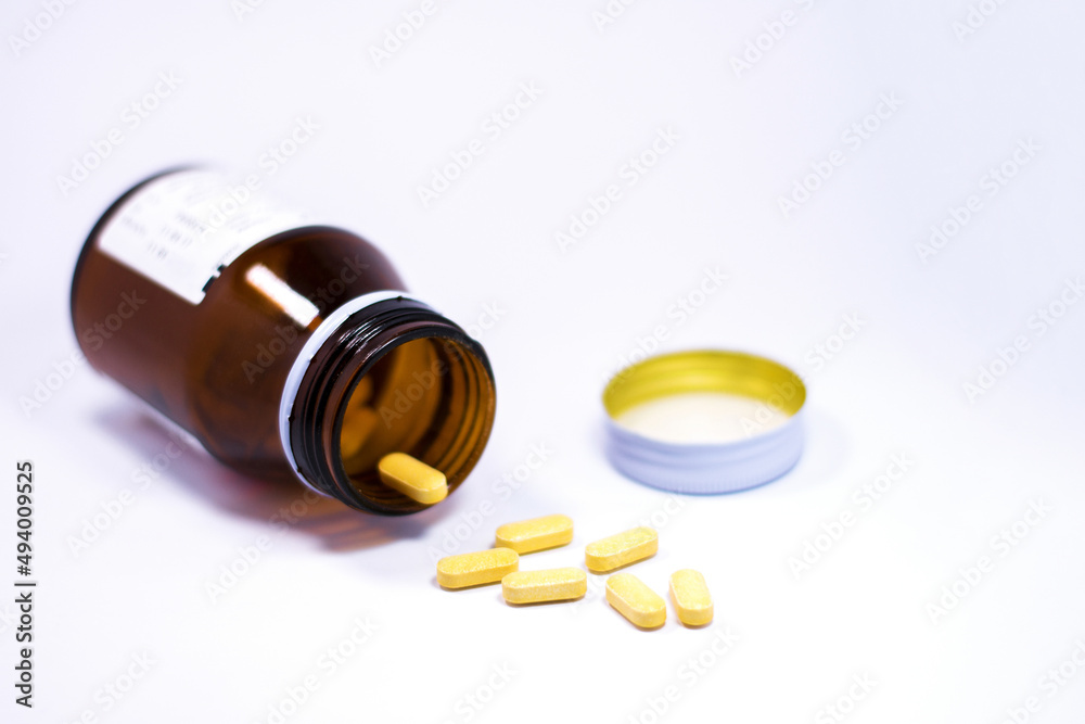 Drug bottle pouring out medicine pills or vitamin isolated. Drug bottle pouring out medicine pills or vitamin isolated.