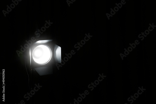 Bright spotlight in darkness, space for text. Professional stage equipment