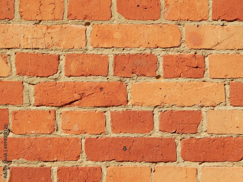 Mur cimenté en briques anciennes incluant plusieurs nuances de rouges-oranges Mur cimenté en briques anciennes incluant plusieurs nuances de rouges-oranges