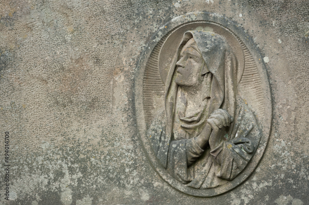 The old sandstone bas-relief of the Virgin Mary