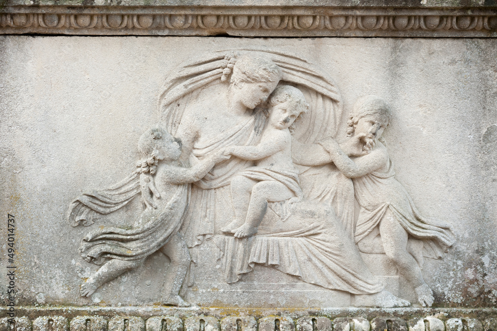 Bas-relief of a young woman embracing her children
