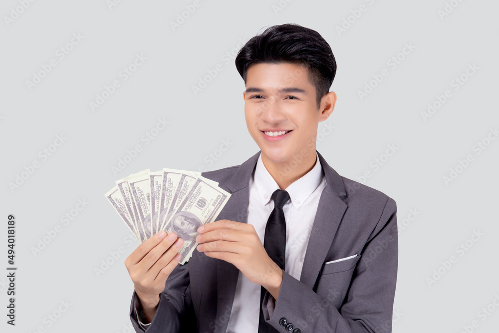 Young asian business man holding money dollar isolated on white background, businessman in suit holding banknote and success and excited with finance, savings and investment, income and spending. Young asian business man holding money dollar isolated on white background, businessman in suit holding banknote and success and excited with finance, savings and investment, income and spending.
