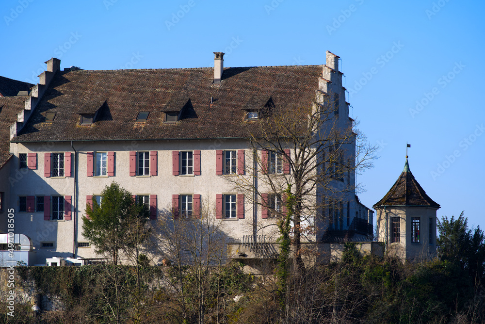 Laufen Castle on a hill above the famous Rhine Falls on a sunny spring day. Photo taken March 5th, 2022, Laufen-Uhwiesen, Switzerland.